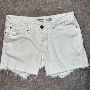 White Denzin from Levis denim low rise cutoff shorts. Women size 9/29 waist.